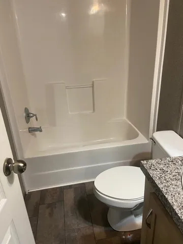 an empty room with wooden floor and a window