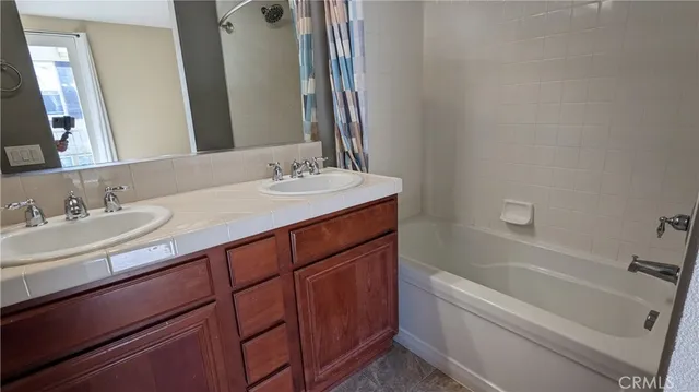 a bathroom with a granite countertop sink a toilet and bathtub