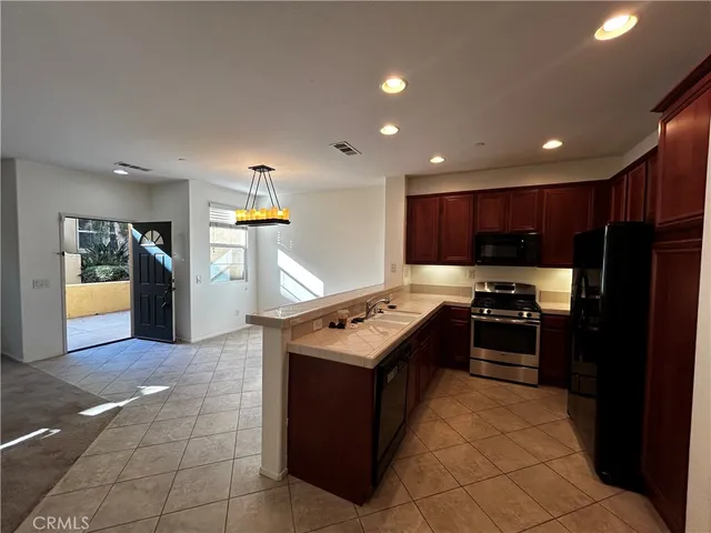 a kitchen with stainless steel appliances granite countertop a stove and a refrigerator