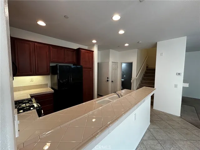 a kitchen with stainless steel appliances a refrigerator and a stove top oven