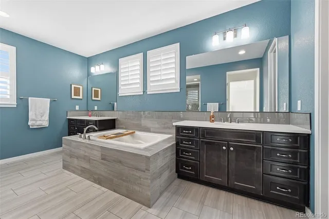 a view of walk in closet with clothes