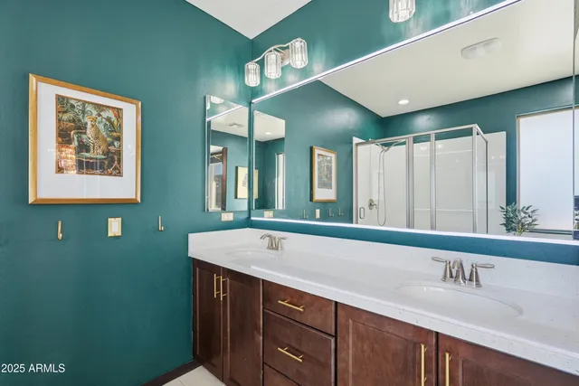 a bedroom with a bed and a large mirror