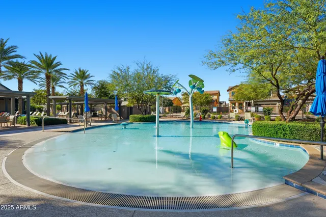 a view of a tennis ground with large trees