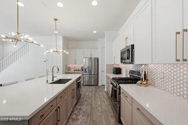 a living room with furniture and a chandelier