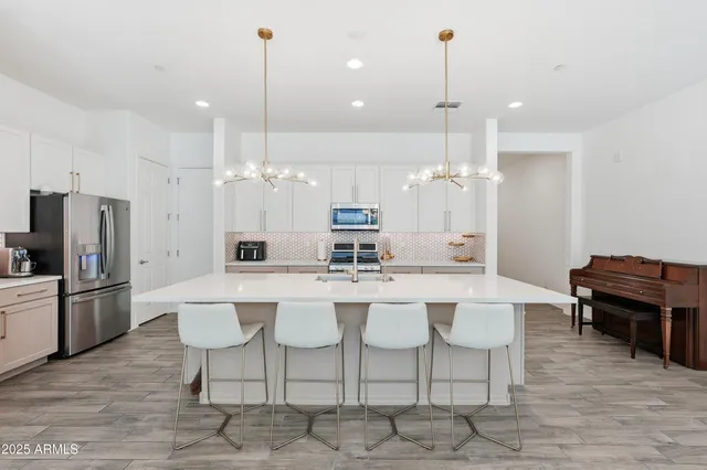 a open kitchen with stainless steel appliances granite countertop a sink stove and wooden floor