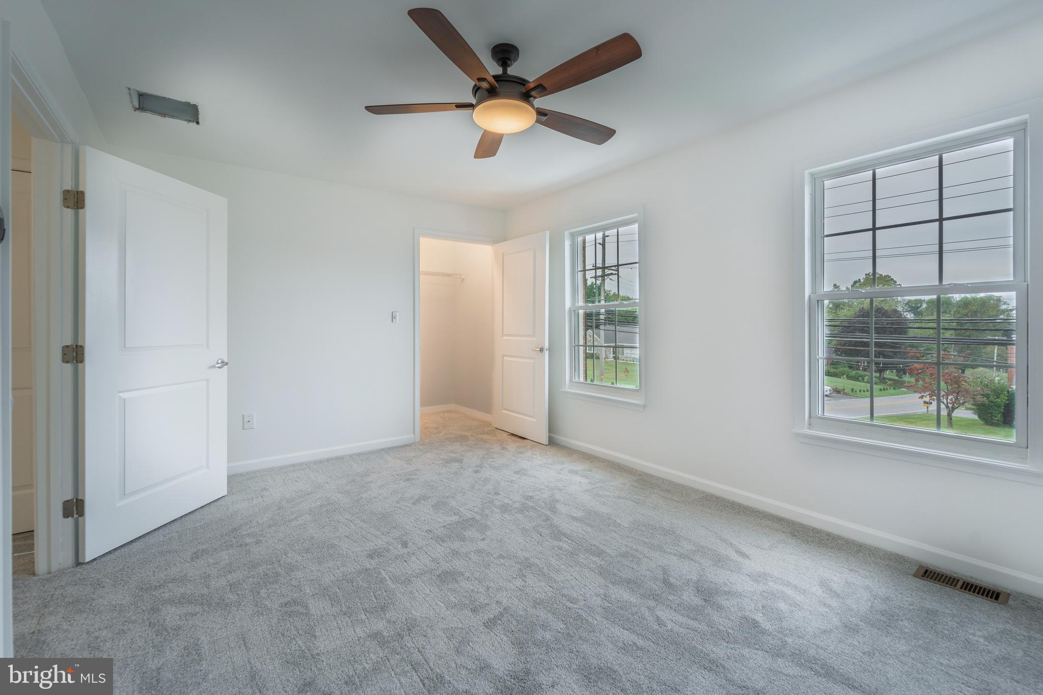 807 Washington Road Westminster, MD 21157 - Photo 14 of 32 an empty room with windows and ceiling fan