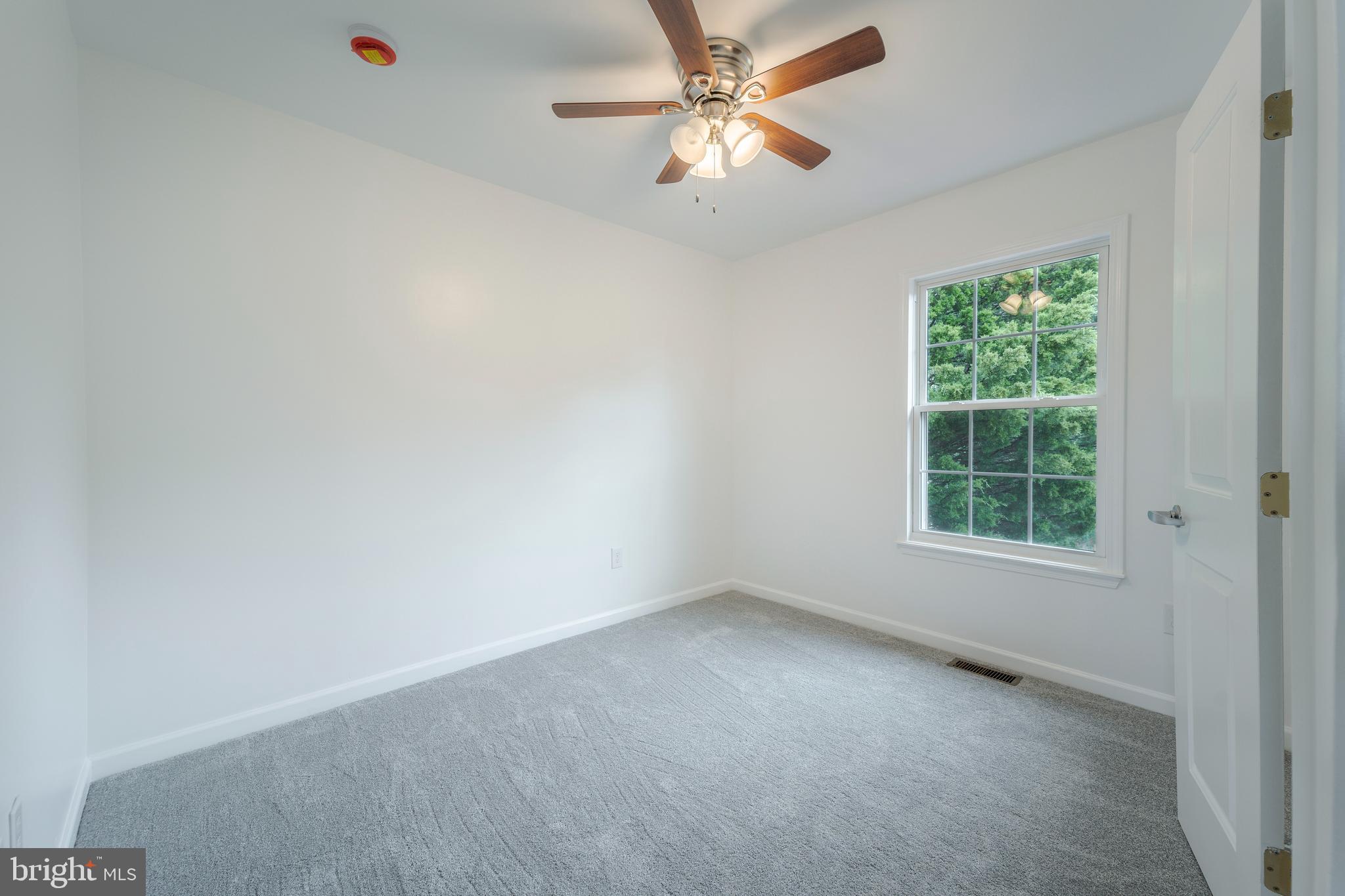 807 Washington Road Westminster, MD 21157 - Photo 17 of 32 an empty room with a window and a fan