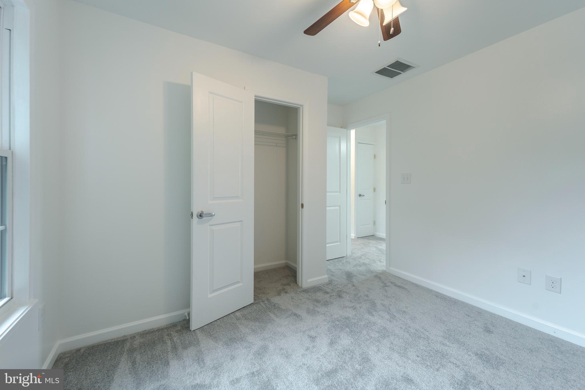 807 Washington Road Westminster, MD 21157 - Photo 18 of 32 an empty room with a fan & a chandelier fan