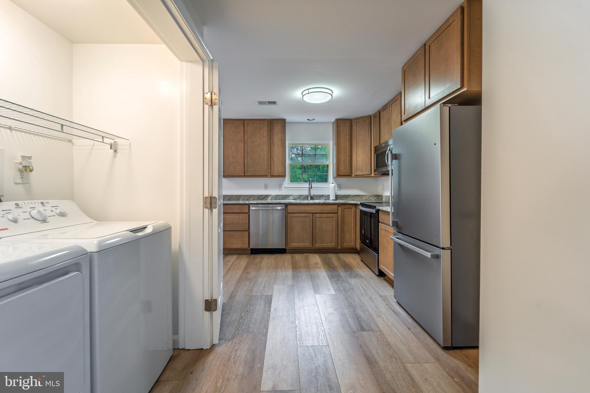 807 Washington Road Westminster, MD 21157 - Photo 5 of 32 a kitchen with wooden cabinets and stainless steel appliances