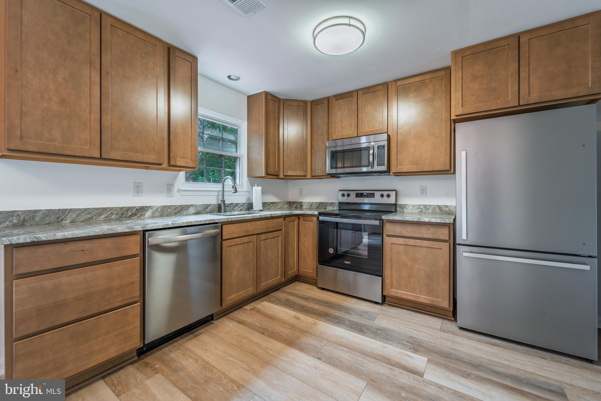 807 Washington Road Westminster, MD 21157 - Photo 8 of 32 a kitchen with stainless steel appliances granite countertop a refrigerator sink and cabinets