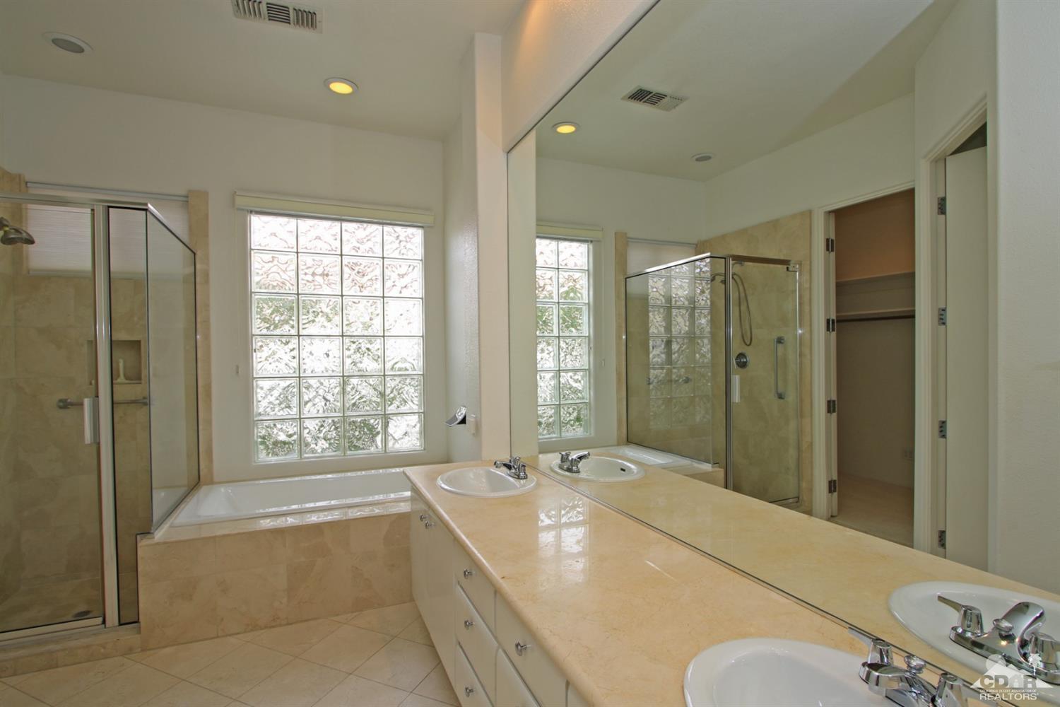 118 Loch Lomond Road Rancho Mirage, CA 92270 - Photo 22 of 42 a spacious bathroom with a tub sink and mirror