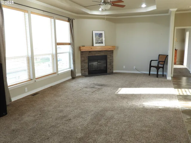 an empty room with furniture and a fireplace