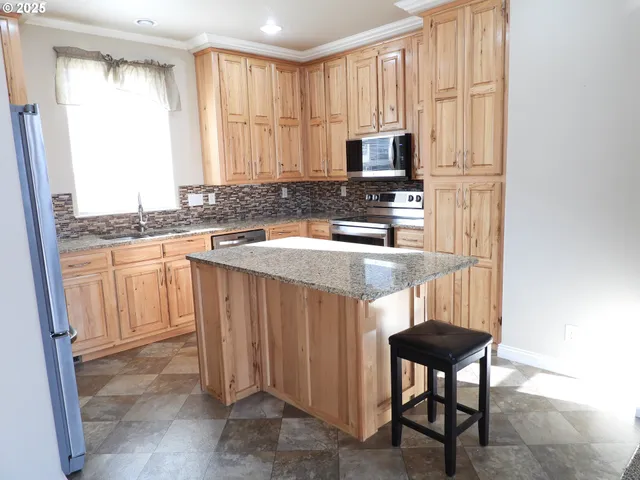 a kitchen with a sink cabinets and window