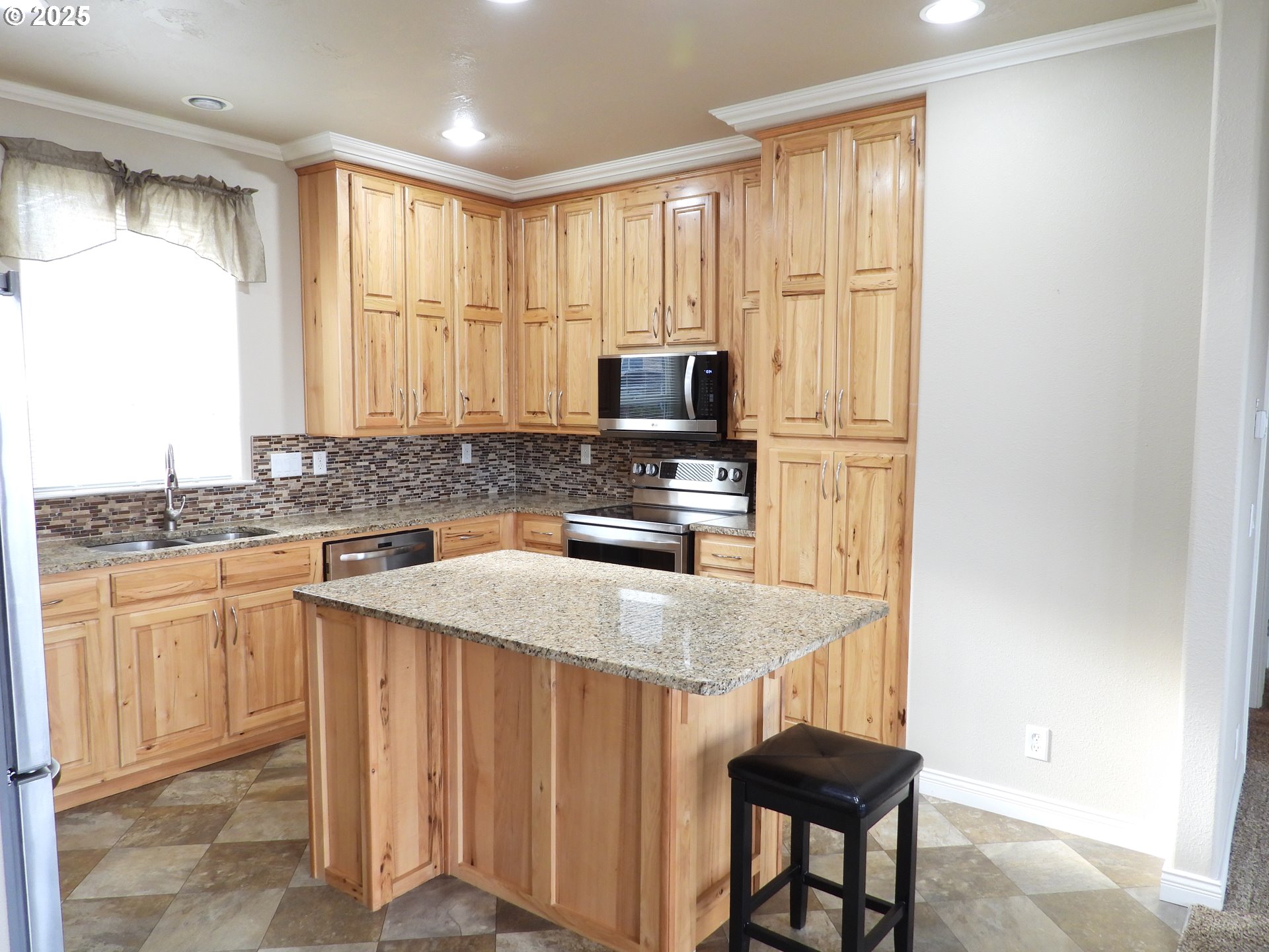 1903 Golden Way The Dalles, OR 97058 - Photo 3 of 22 a kitchen with granite countertop a stove a sink and a refrigerator