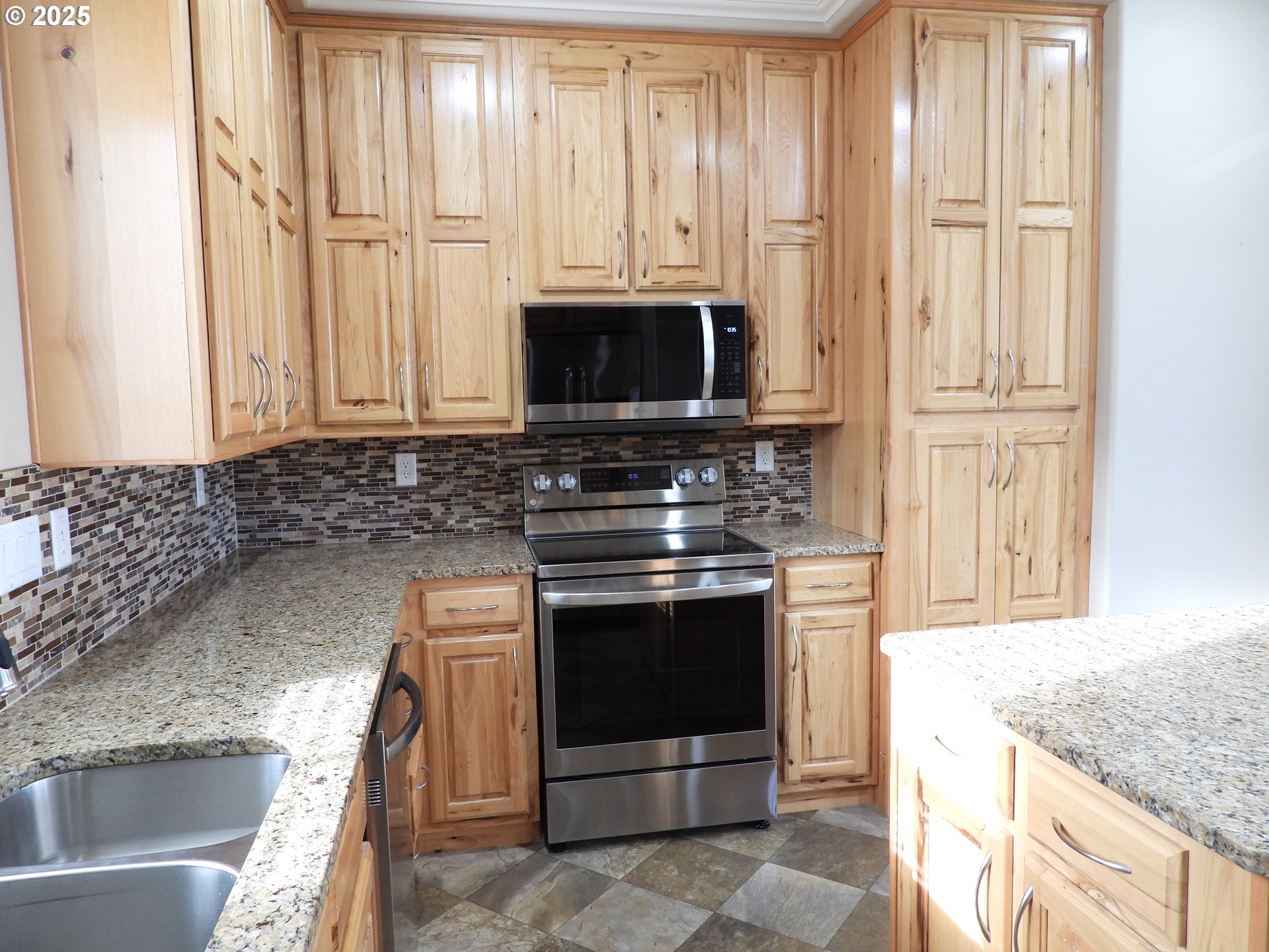 1903 Golden Way The Dalles, OR 97058 - Photo 4 of 22 a kitchen with granite countertop a stove top oven microwave and cabinets