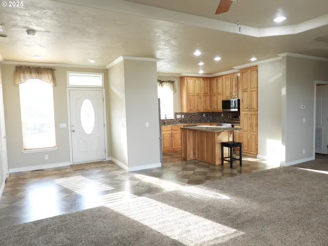 a view of a kitchen with a sink a refrigerator and a window