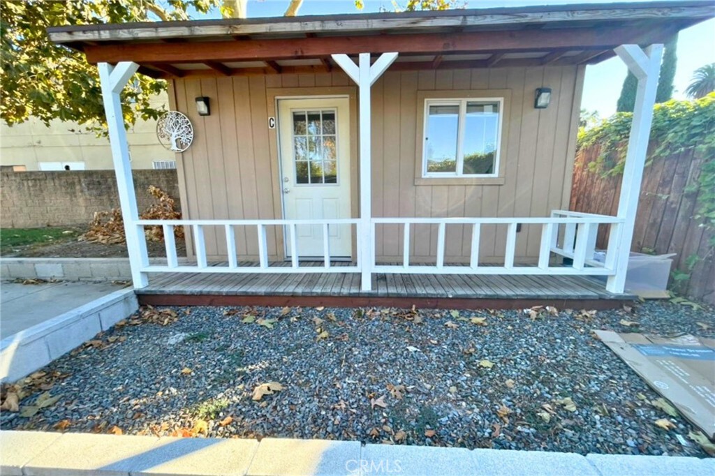 a view of a house with a small yard and wooden floor