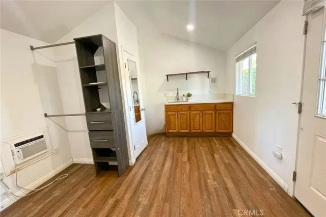 a kitchen with granite countertop white cabinets and stainless steel appliances