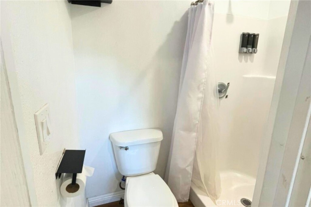 852 North Lugo Avenue, Unit C San Bernardino, CA 92410 - Photo 8 of 8 a white toilet sitting next to a shower