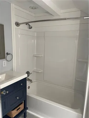 a bathroom with a bathtub vanity and a shower