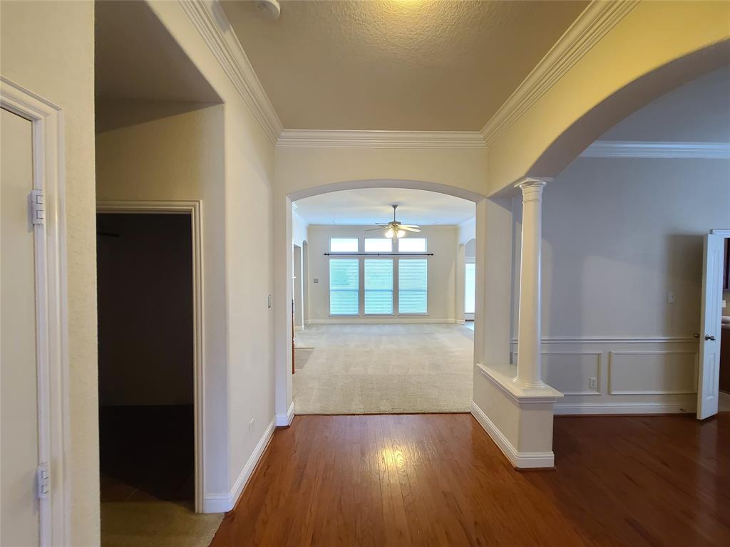 9729 Stripling Drive Fort Worth, TX 76244 - Photo 14 of 40 a view of an empty room with wooden floor and a window