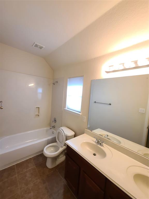 9729 Stripling Drive Fort Worth, TX 76244 - Photo 17 of 40 a bathroom with a double vanity sink toilet and a tub