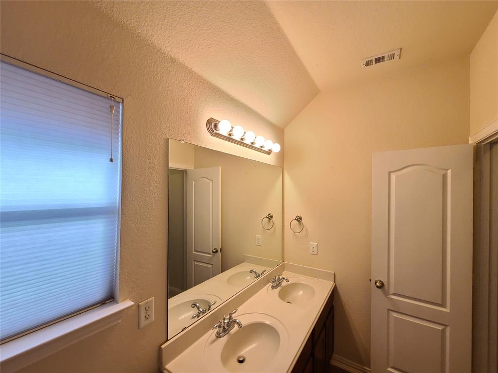 9729 Stripling Drive Fort Worth, TX 76244 - Photo 19 of 40 a bathroom with a sink and a mirror
