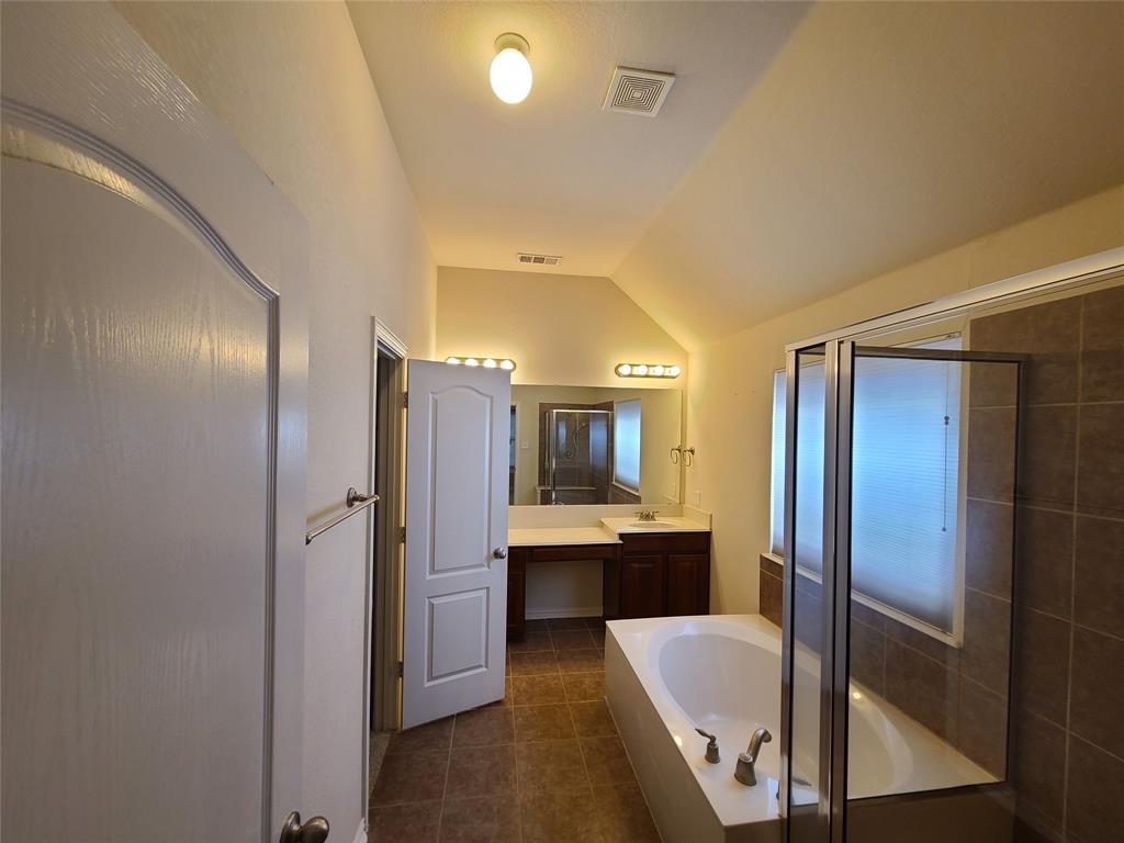 9729 Stripling Drive Fort Worth, TX 76244 - Photo 25 of 40 a bathroom with a tub and shower