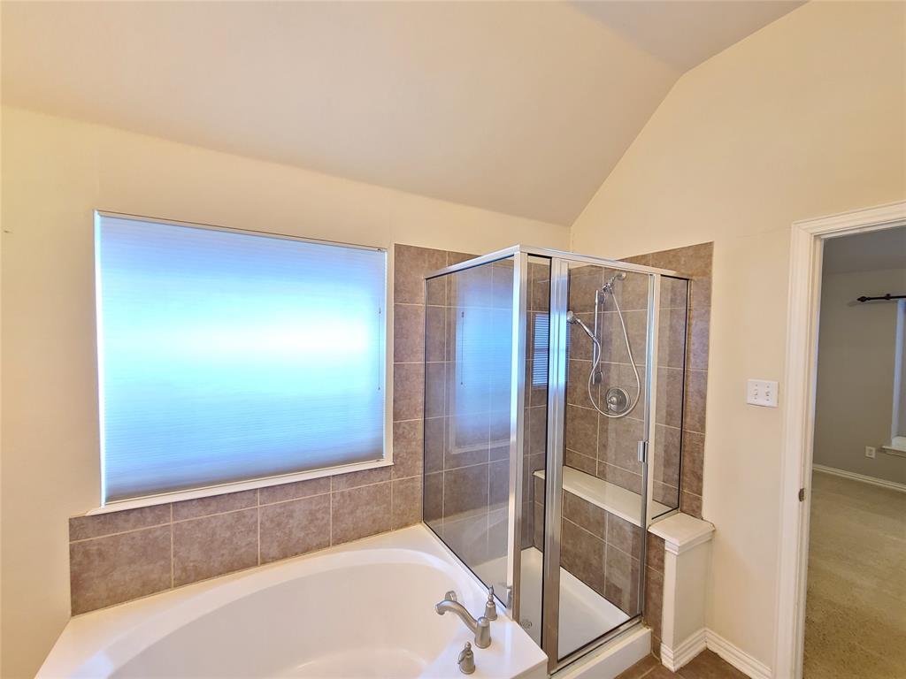 9729 Stripling Drive Fort Worth, TX 76244 - Photo 28 of 40 a bathroom with a bathtub and a shower