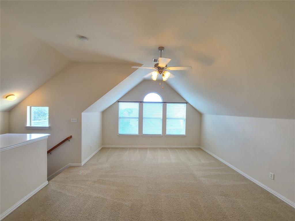 9729 Stripling Drive Fort Worth, TX 76244 - Photo 32 of 40 an empty room with chandelier fan and windows