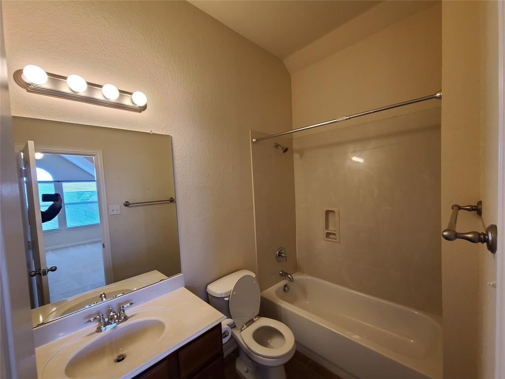 9729 Stripling Drive Fort Worth, TX 76244 - Photo 33 of 40 a bathroom with a sink a toilet and shower