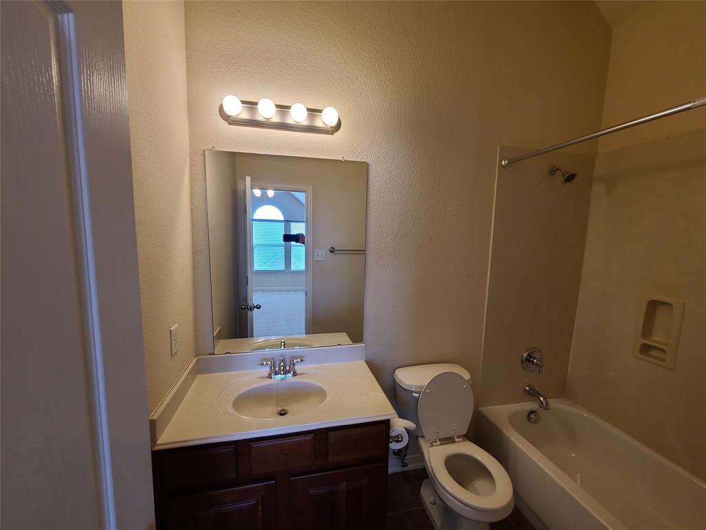 9729 Stripling Drive Fort Worth, TX 76244 - Photo 34 of 40 a bathroom with a sink a toilet and shower
