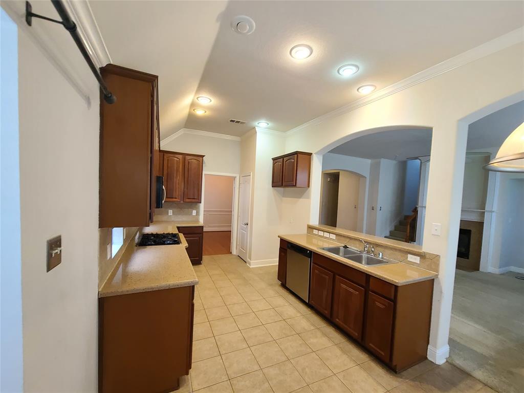 9729 Stripling Drive Fort Worth, TX 76244 - Photo 10 of 40 a kitchen with stainless steel appliances granite countertop a stove a sink and a refrigerator