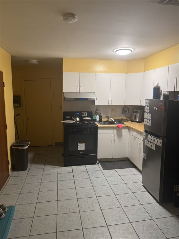 65-65A Beach Street Boston, MA 02111 - Photo 7 of 13 a kitchen with a sink a stove and a refrigerator