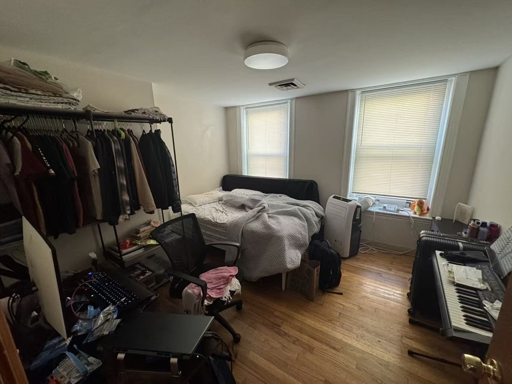 65-65A Beach Street Boston, MA 02111 - Photo 9 of 13 a bed room with a bed and a window