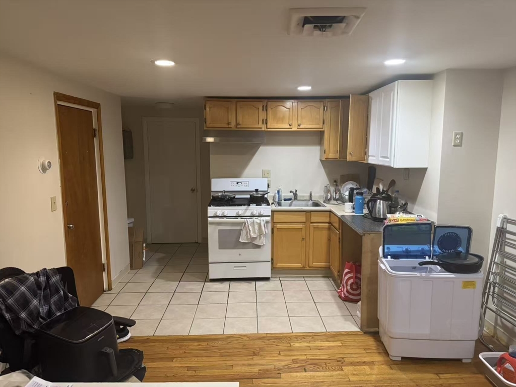 65-65A Beach Street Boston, MA 02111 - Photo 10 of 13 a kitchen with a sink appliances and cabinets
