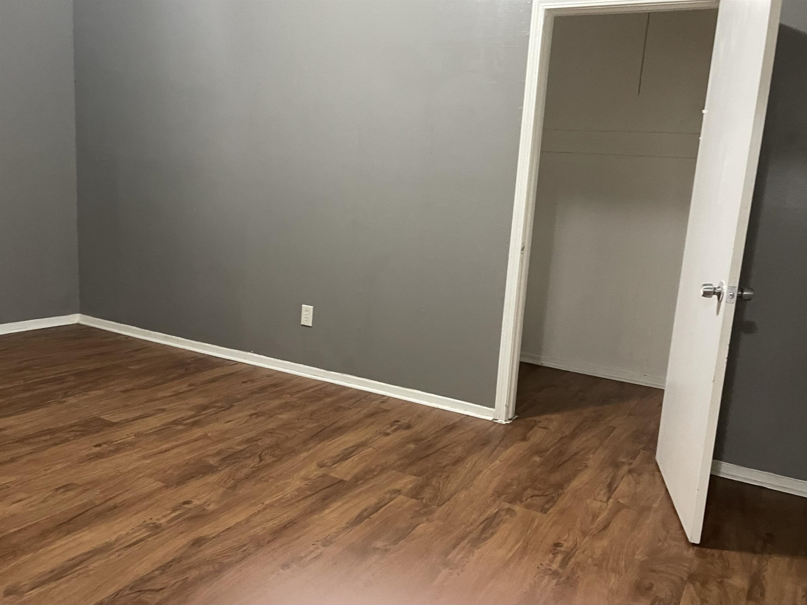 3312 Powell Avenue Memphis, TN 38122 - Photo 12 of 15 an empty room with wooden floor and entrance
