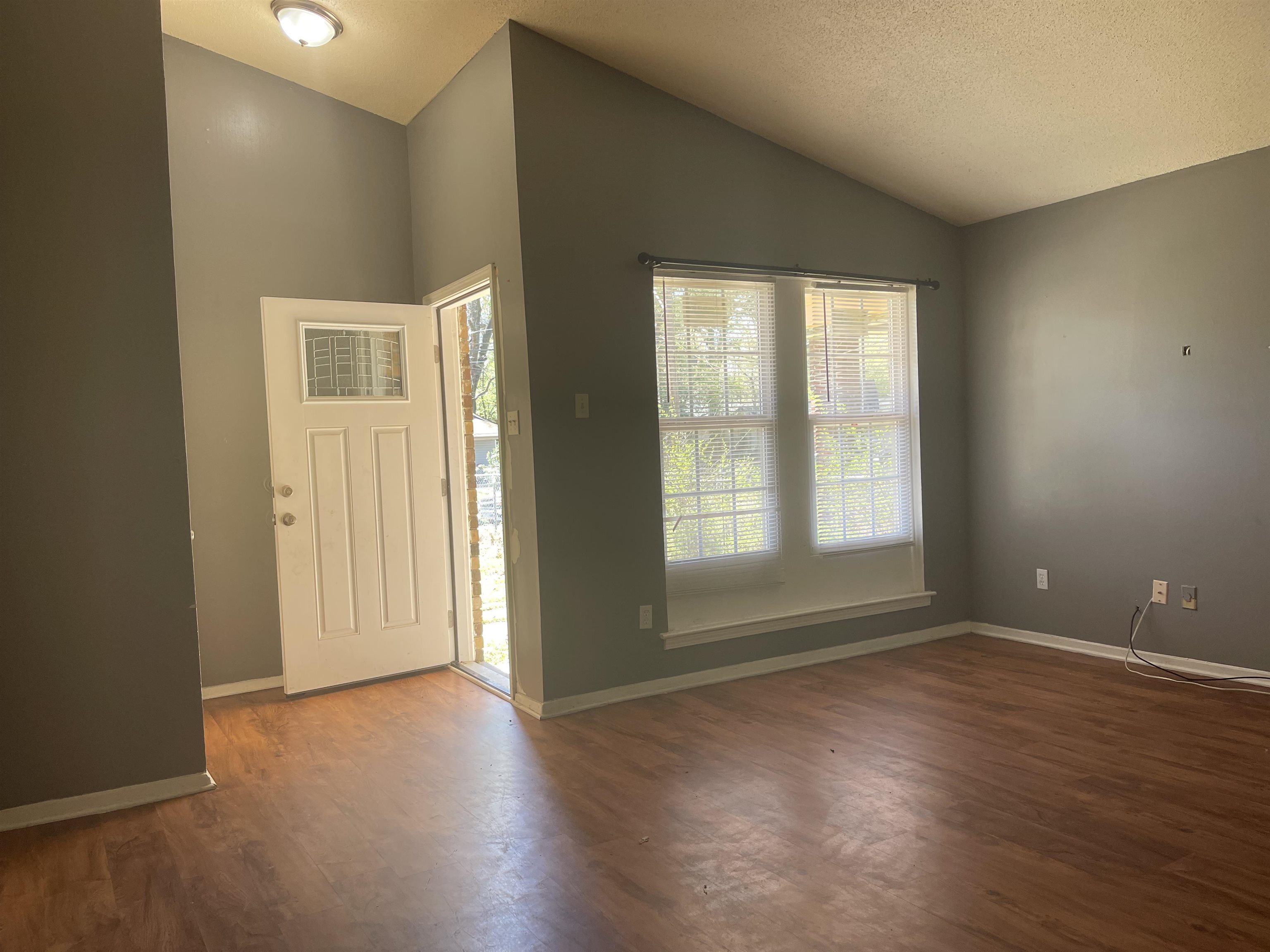3312 Powell Avenue Memphis, TN 38122 - Photo 3 of 15 a view of an empty room with wooden floor and a window