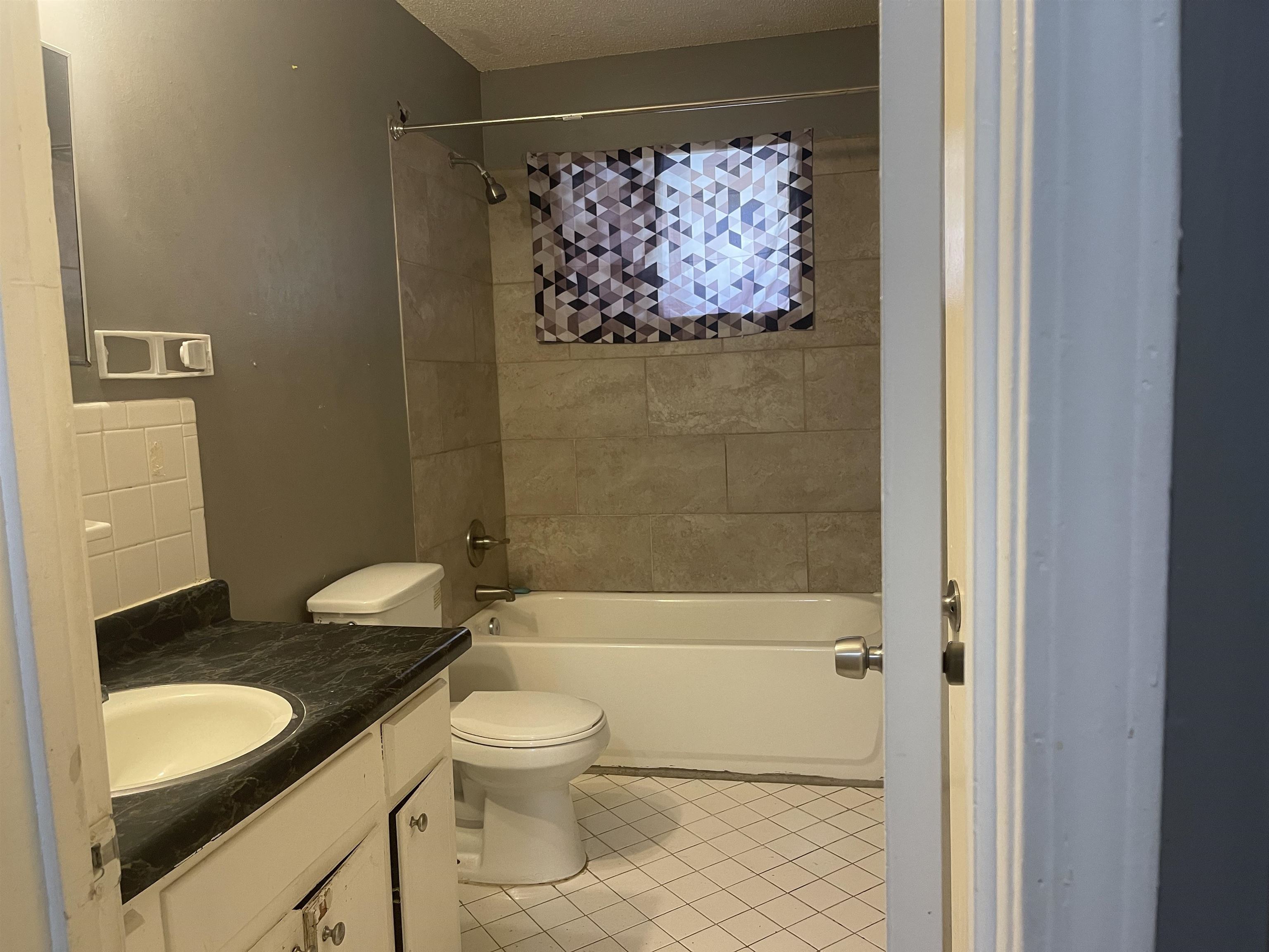 3312 Powell Avenue Memphis, TN 38122 - Photo 7 of 15 a bathroom with a granite countertop sink toilet and shower