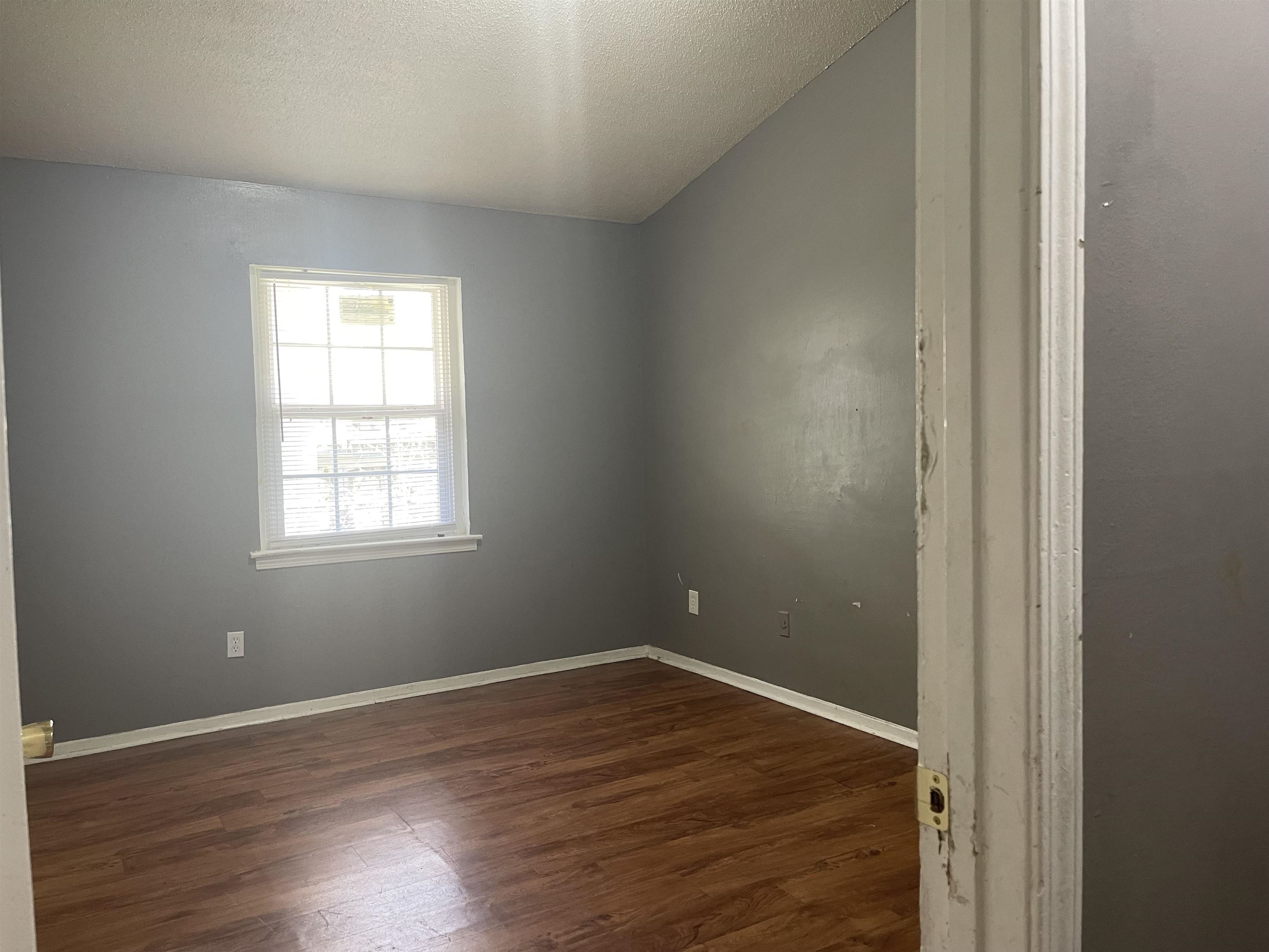 3312 Powell Avenue Memphis, TN 38122 - Photo 9 of 15 an empty room with wooden floor and windows