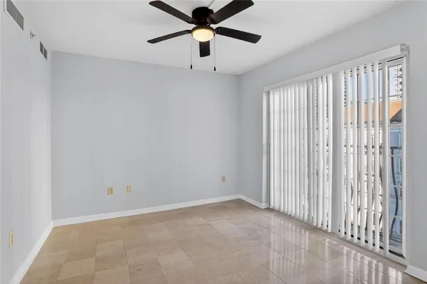 a view of empty room with ceiling fan