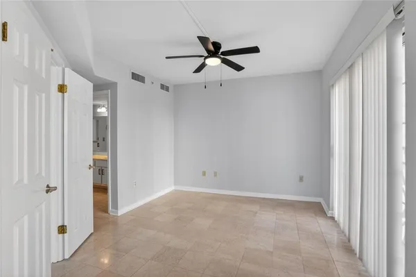 a view of a livingroom with a chandelier fan and closet area