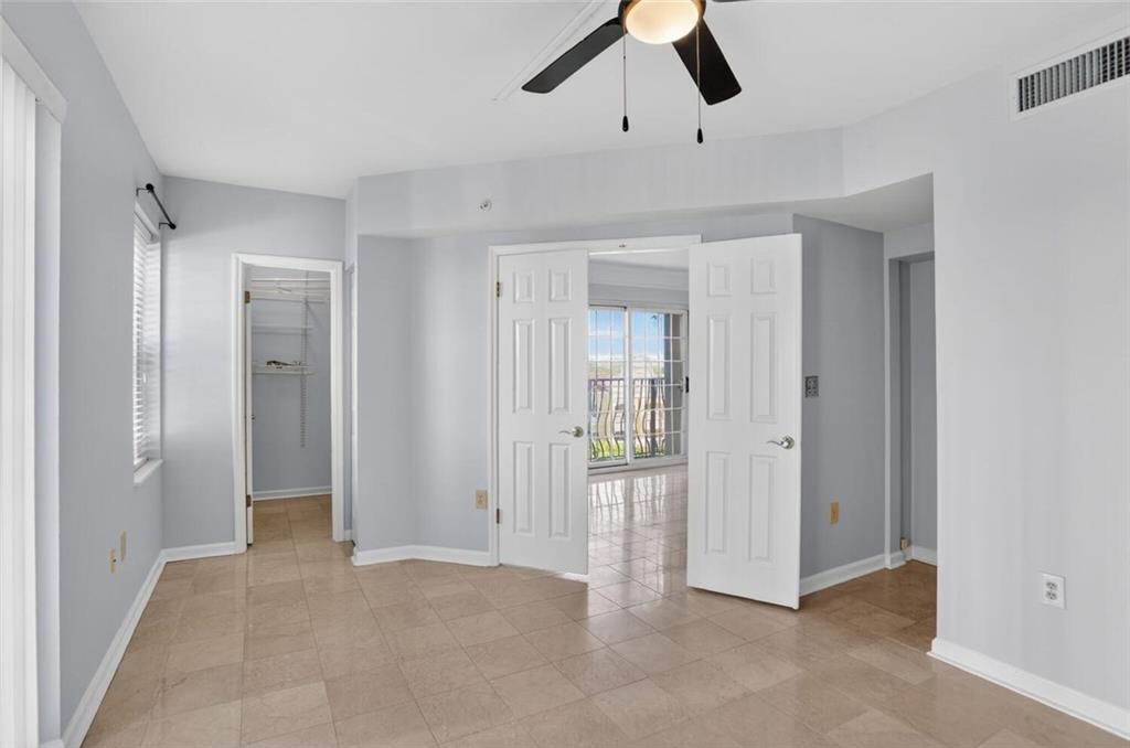 199 14th Street Northeast, Unit 711 Atlanta, GA 30309 - Photo 14 of 22 a view of a livingroom with a chandelier fan and closet area