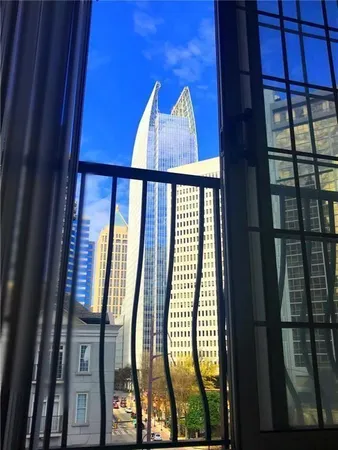 a living room with hardwood floor and a window