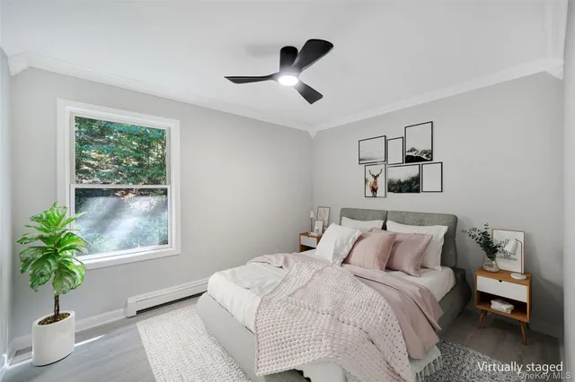 a bedroom with a bed and a potted plant