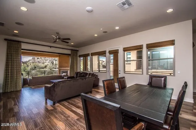 a view of a hallway with wooden floor and a bathroom
