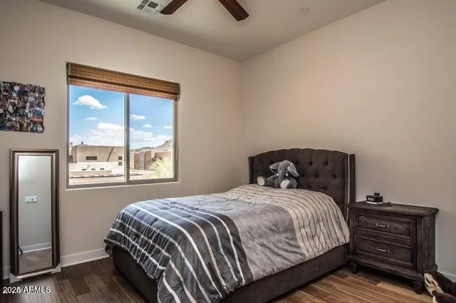 a bedroom with a bed couch and window
