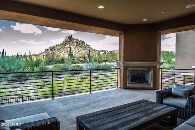a view of a kitchen with kitchen island and stainless steel appliances