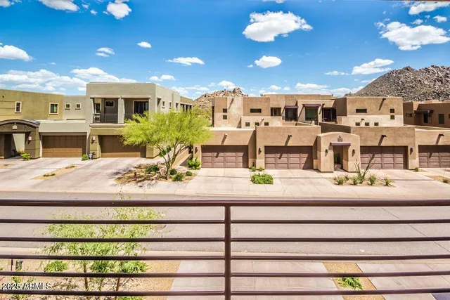 a kitchen with granite countertop kitchen island stainless steel appliances a dining table and chairs