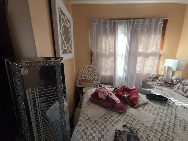 a bed room with two beds and a window